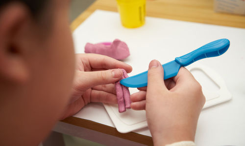 Cropped hand of doctor examining patient at home