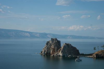 Scenic view of sea and mountains against sky