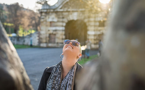 Portrait of happy woman looking away outdoors