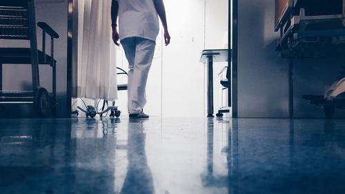 Low section of nurse walking in hospital ward