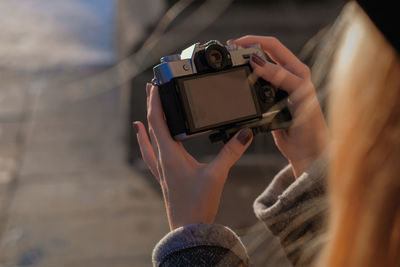 Midsection of woman photographing