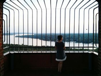 Woman standing on railing