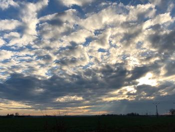 Scenic view of field against sky at sunset