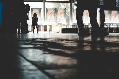 Low section of people walking in corridor