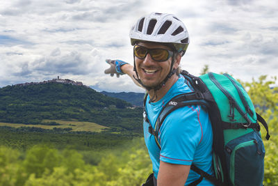 Portrait of man wearing hat against mountains