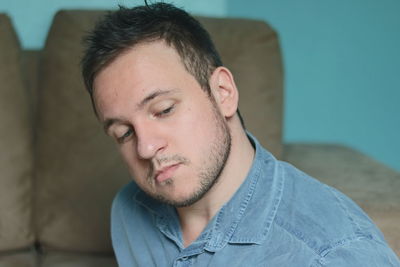 Portrait of young man looking away at home