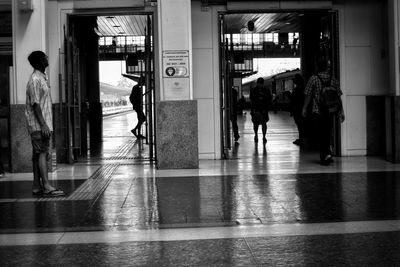 People walking in corridor of building