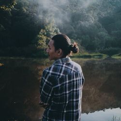 Man standing by tree against mountain