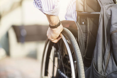 Cropped image of man in wheelchair outdoors