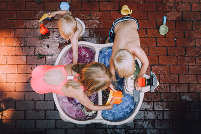 Directly above shot of siblings playing with water