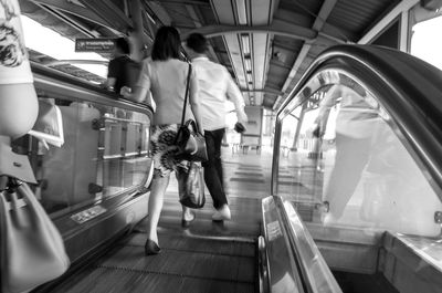 People walking on escalator