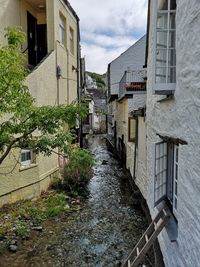 Canal amidst buildings against sky