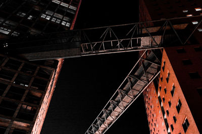 Low angle view of illuminated construction site at night