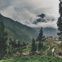 Scenic view of mountains against cloudy sky