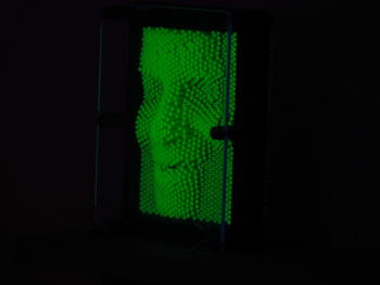 Close-up of illuminated light against black background