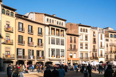 Group of people in city against buildings