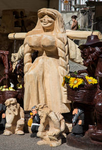 Statue of people at market stall