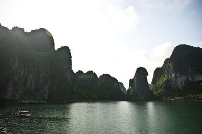 Scenic view of sea with mountain range in background