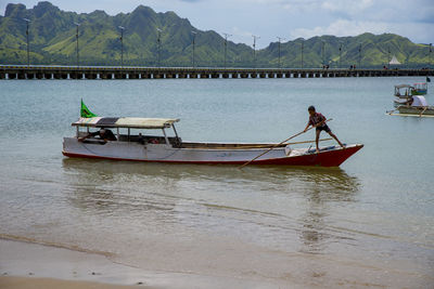 Boat moored in river against sky