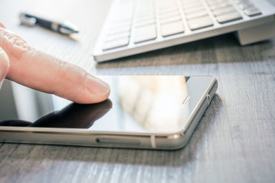 Close-up of hand holding mobile phone