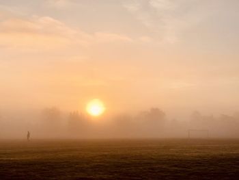 Scenic view of field against sky during sunset