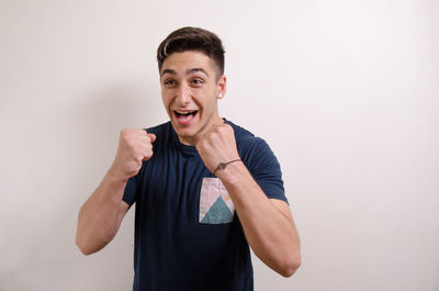 Portrait of smiling young man against white background