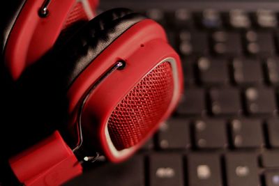High angle view of red headphones on keyboard
