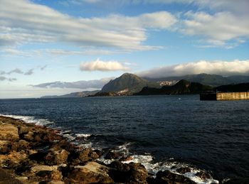 Scenic view of mountains against cloudy sky