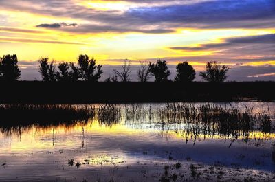 Scenic view of lake against orange sky