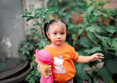 Portrait of cute girl standing outdoors