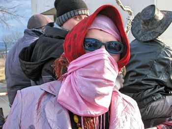 Portrait of woman wearing scarf and sunglasses in sunny day