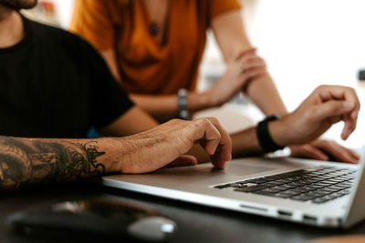 Detail of hand in laptop of couple having video conversation at home