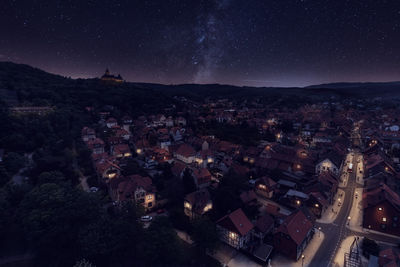 High angle view of illuminated buildings in city at night