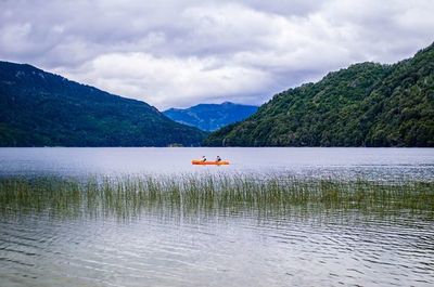 Scenic view of calm lake against mountain range