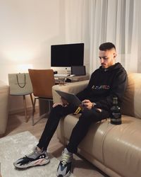 Young man sitting on sofa