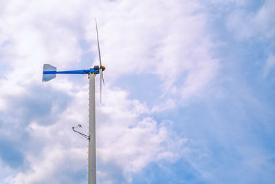 Low angle view of windmill against sky