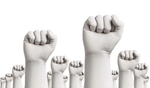 Close-up of hands against white background