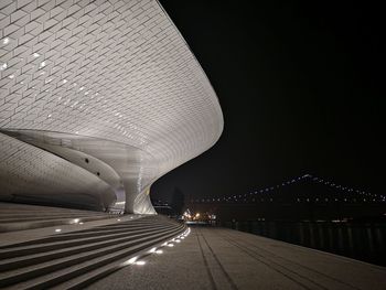 Illuminated bridge against sky at night