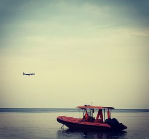 Boat in sea against sky