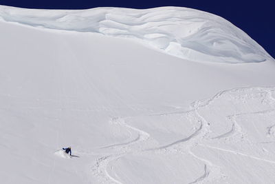 People skiing on snowcapped mountain