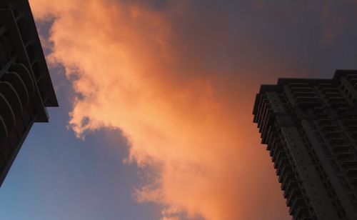 Low angle view of building against cloudy sky