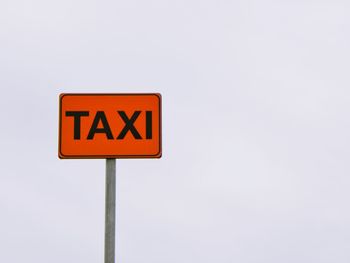 Low angle view of road sign against clear sky