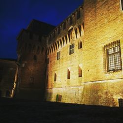 Low angle view of old building against sky at night