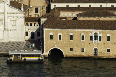 Bridge over river by buildings in city