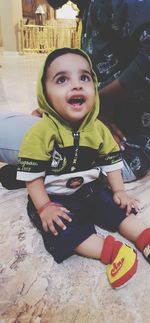 Portrait of a smiling boy sitting outdoors