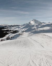 Scenic view of snow covered mountains against sky