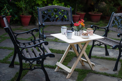 Empty chairs and table at yard