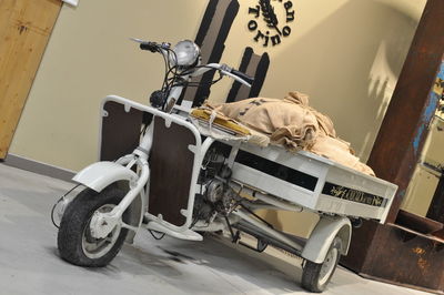 Vehicles on street against wall in city