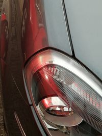 Close-up of illuminated red car in city