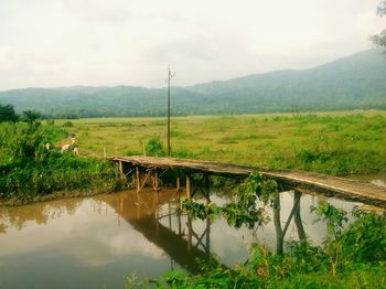 Scenic view of lake against cloudy sky